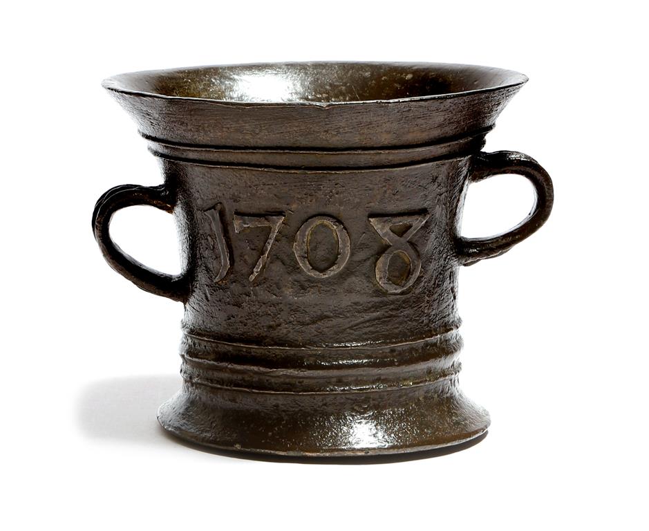 A Queen Anne dated bronze mortar attributed to Ralph Ashton of Wigan, the reeded body with owner's