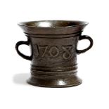 A Queen Anne dated bronze mortar attributed to Ralph Ashton of Wigan, the reeded body with owner's