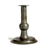 A pewter candlestick, with a turned trumpet stem, 17cm high.