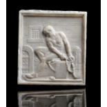 After the antique. A relief carved marble plaque depicting a chained slave in a cell, probably Rome,