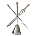 A set of three Victorian steel fire tools, each with a cartouche and mask gilt brass handle, with