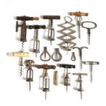 A collection of seventeen various corkscrews, including: a bone and brass pull example fitted with a