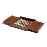 λ A mahogany travelling chess set, the folding case with carved bone pieces, natural and stained