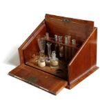 An Edwardian mahogany travelling chemist's box by S. Maw, Son & Sons Ltd., with a retractable