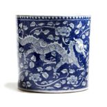 A Chinese blue and white cylindrical brushpot, painted with a pair of scaly dragons, with