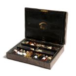 A Victorian leather 'miniature dispensary' apothecary's box by Kirby & Co., the hinged lid revealing