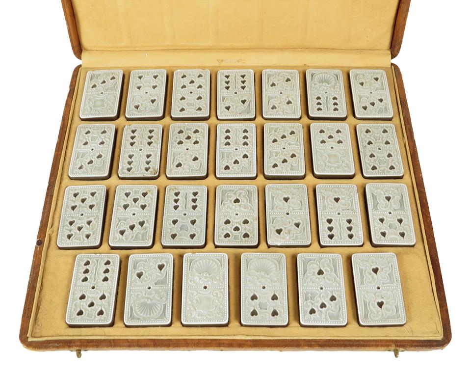 A set of early 19th century carved agate dominoes, in a leather case, probably Italian, each domino: