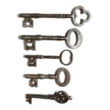 Five steel and iron keys, one with a Gothic pierced handle and one with a trefoil handle, 17th