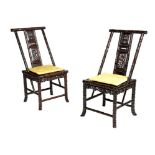 A pair of Chinese hardwood faux bamboo chairs, each carved with bamboo leaves, the pierced splat