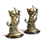 A pair of Victorian brass doorstops, each modelled with the infant Hercules strangling a snake,