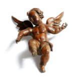 A continental carved pine figure of a winged cherub, probably 18th century, 39.4cm high. Provenance: