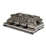 A large polished cast iron inkstand in the form of a cash register, with all over scroll and foliate