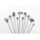 A collection of ten hat pins, comprising: a silver one modelled as a bicycle, Birmingham 1896,