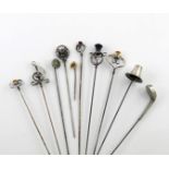 A collection of ten hat pins, comprising: a silver one modelled as a Welsh hat, by Charles Horner,