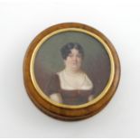 λA 19th century burr birch portrait snuff box, circular form, the pull-off cover with a miniature