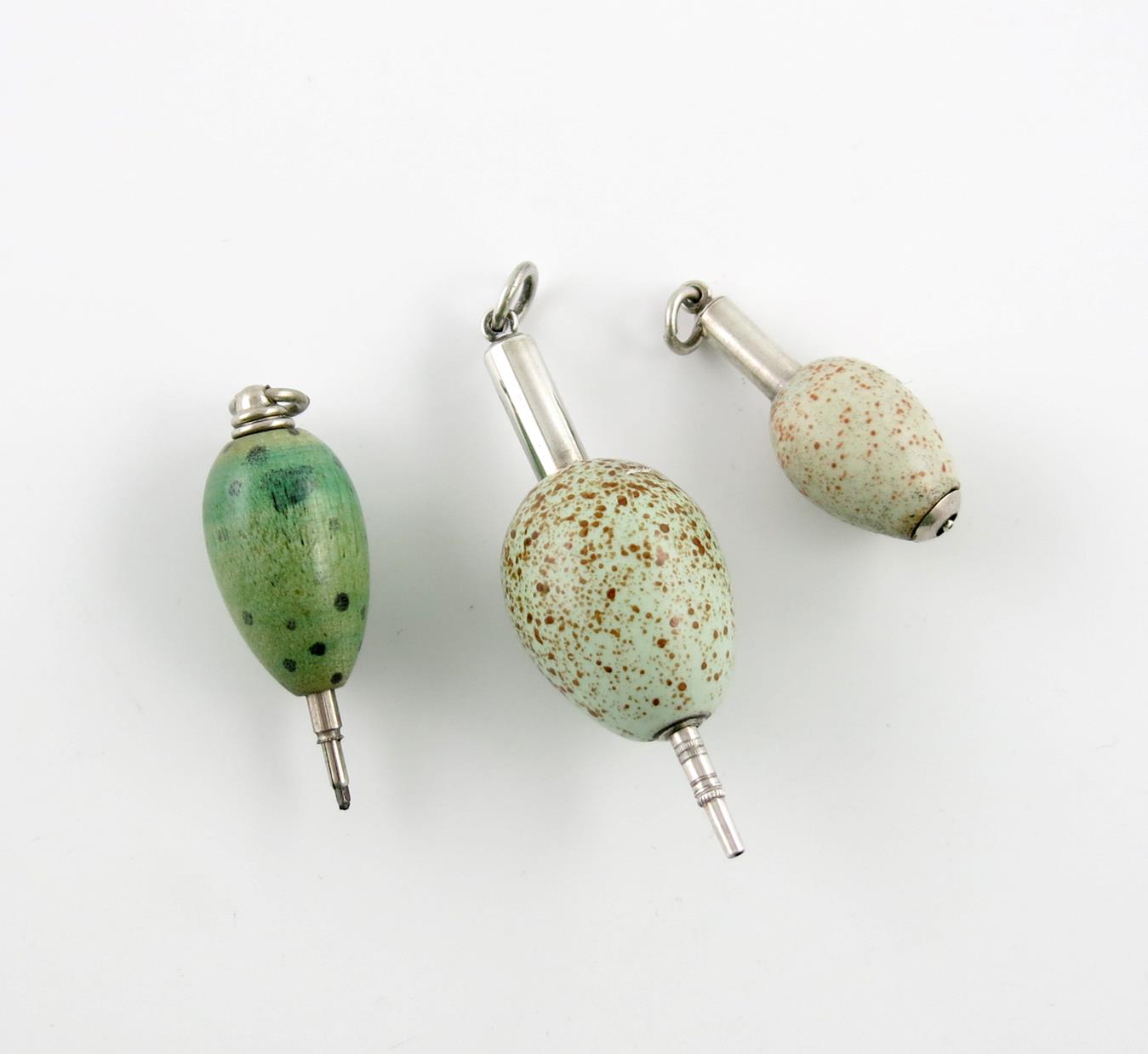 λA collection of three Victorian novelty telescopic egg pencils, comprising: a porcelain cuckoo egg,