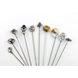 A collection of ten silver hat pins, comprising: a silver and hard stone one, marked sterling