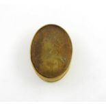 An early 18th century pressed horn snuff box, oval form, the cover with a portrait of Queen Anne,