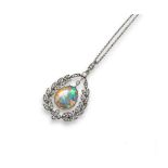 An Edwardian opal and diamond pendant, the fine pear-shaped opal suspends from a laurel form