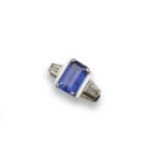 A tanzanite and diamond cluster ring, the emerald-cut tanzanite is set with two tapered baguette-