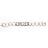An early 20th century diamond bracelet, the central rectangular pierced plaque is millegrain-set