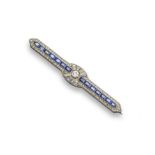 A sapphire and diamond bar brooch, set with a central line of calibre-cut sapphires within an