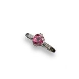 A spinel and diamond ring, the slightly oval-shaped deep pink spinel is set with six small
