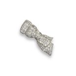 A 1930s diamond set bow brooch, the tied ribbon in three sections and millegrain-set overall with