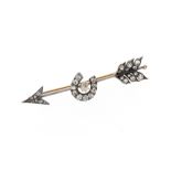 A late Victorian diamond-set arrow brooch, the realistically designed arrow with a horseshoe to