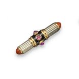 An Art Deco bar brooch by Lacloche, designed as a cylinder centred with three cabochon rubies set to