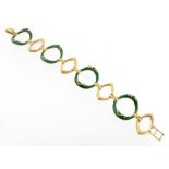 A fancy-link gold bracelet, designed as alternating textured lozenge links and green enamel circular