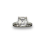 A diamond solitaire ring, the slightly rectangular emerald cut diamond weighs approximately 4.