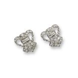 A pair of diamond set clip brooches, of stylised tied fleur-de-lys form and set overall with