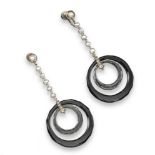 A pair of Art Deco earrings, set with concentric circles of black onyx and rock crystal, sespended