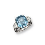An aquamarine and diamond ring, the step-cut aquamarine is set with three graduated baguette-