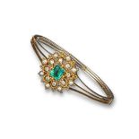 A 19th century emerald diamond and pearl set gold hinged bangle, the detachable centre section is