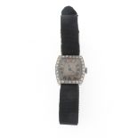 A lady's diamond-set Art Deco platinum wristwatch, the tonneau-shaped dial with Roman numerals and