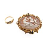 A late 19th century shell cameo brooch, depicting a seated woman carving a bust, with a putti,