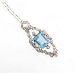 An aquamarine and diamond pendant, the emerald-cut aquamarine is set within a diamond set scroll