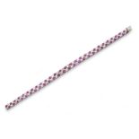 A ruby and diamond chequerboard bracelet, set with graduated oval-shaped rubies and circular-cut