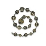 A silver mounted bead necklace attributed to Dorrie Nossiter, alternately-set with banded agate