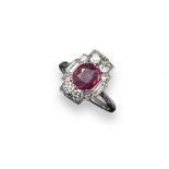 An Art Deco ruby and diamond cluster ring, the oval shaped ruby is set with two baguette-shaped