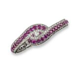 A diamond and Burma ruby bracelet, designed with two curved lines of graduated circular cut and oval