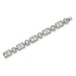 An Art Deco diamond set bracelet, mounted with five rectangular open work links, each millegrain-set