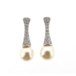 A pair of cultured pearl and diamond drop earrings, the upper sections of millegrain-set circular-