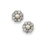 A pair of pearl and diamond cluster earrings, each natural saltwater pearl is set within a