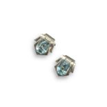 A pair of aquamarine clip earrings, of geometric design, the emerald-cut aquamarines are set in