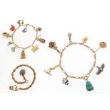 Two gold charm bracelets, each containing various gem-set, articulated and enamel charms including a