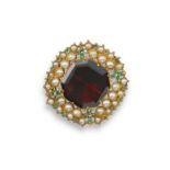 A large and flat octagonal garnet set brooch, set within a surround of graduated seed pearls and