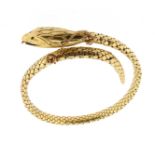 A gold snake bangle, the stylised serpent has a flexible, articulated body, and with rubies set to